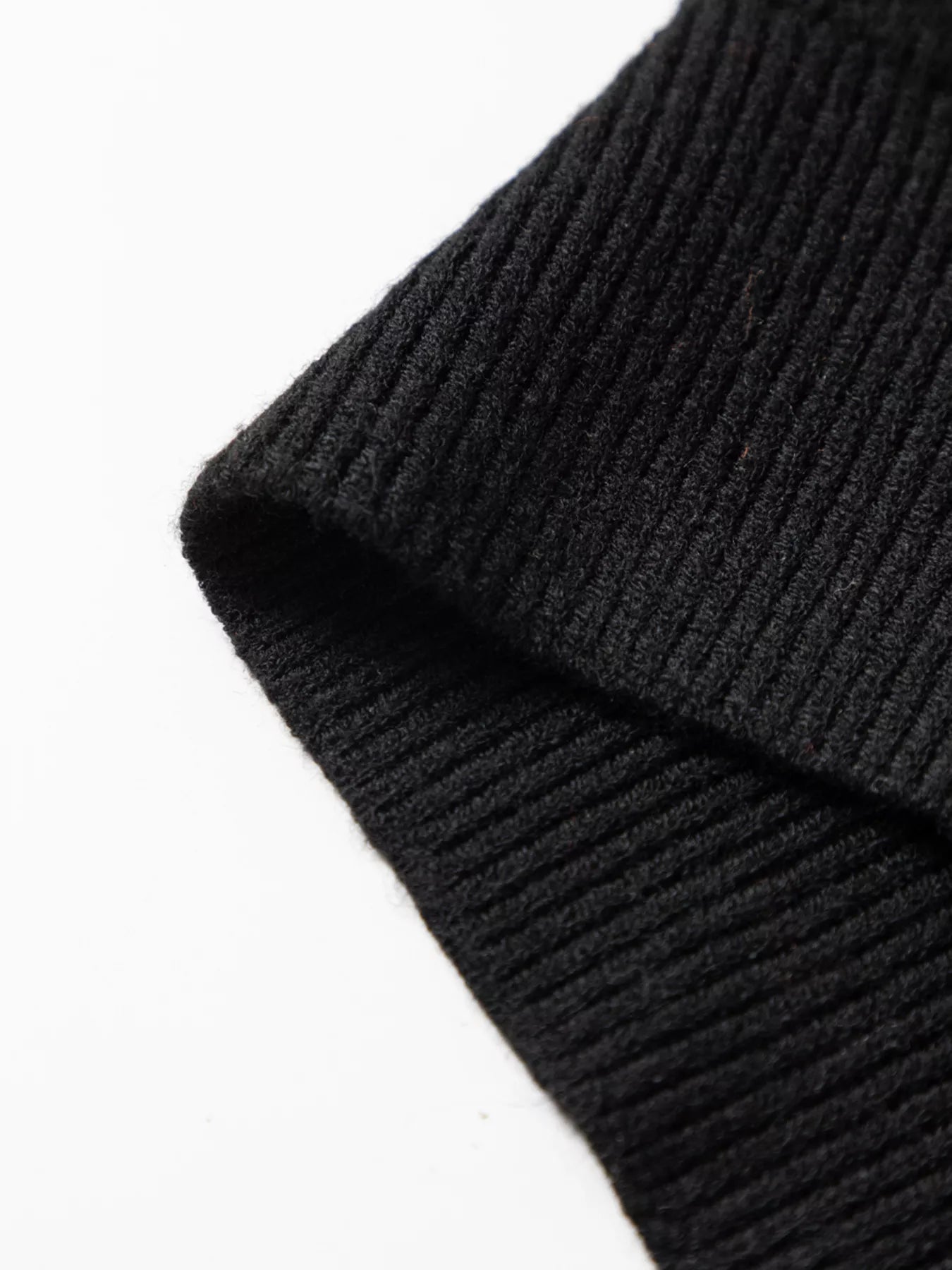 Close-up of a black ribbed knit fabric.