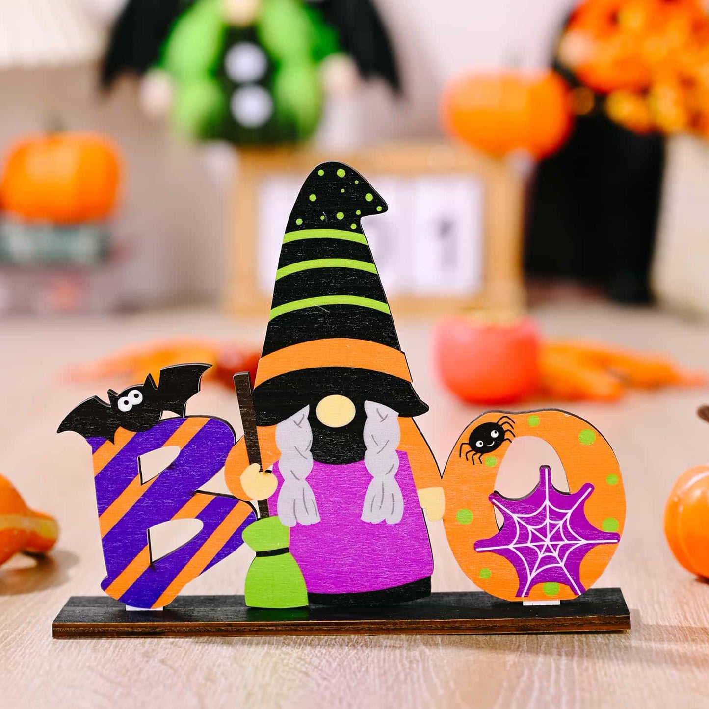A wooden Halloween "BOO" sign featuring a witch gnome.