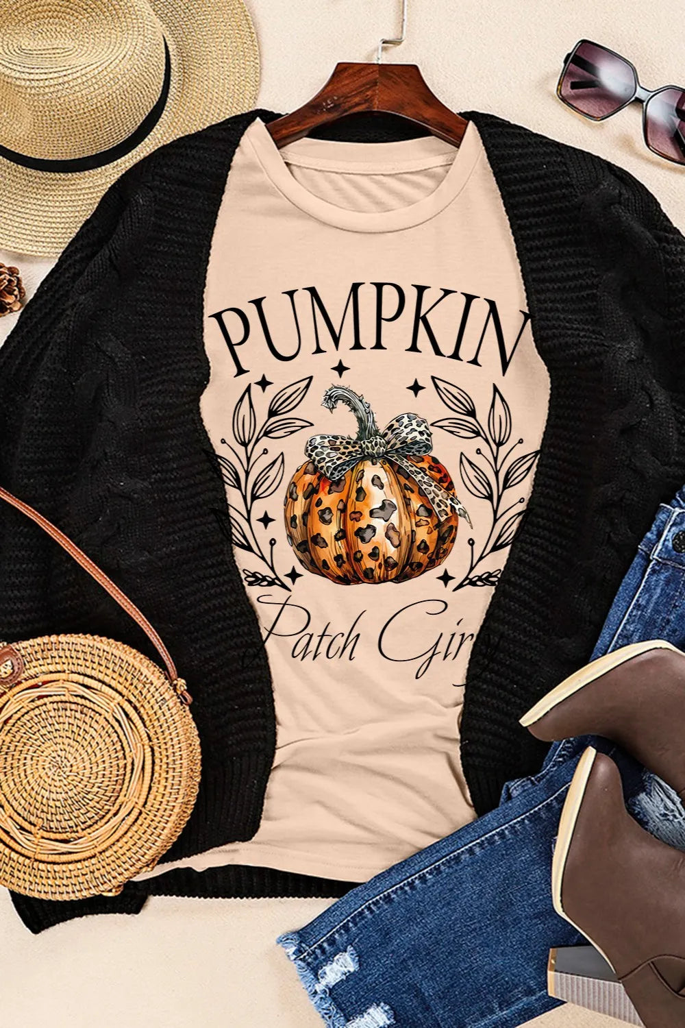 A light-colored t-shirt with a "Pumpkin Patch Girl" graphic and a black cardigan.