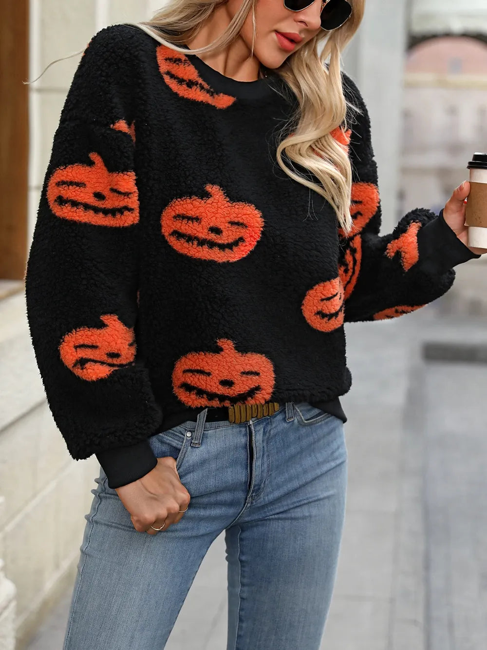 Fuzzy pumpkin round neck dropped shoulder sweater with a woman wearing it.