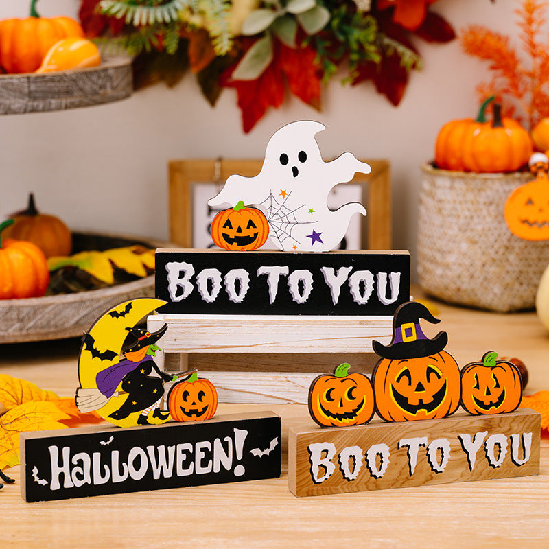 Assorted Halloween ornaments including ghosts, pumpkins, and witches on wooden blocks.