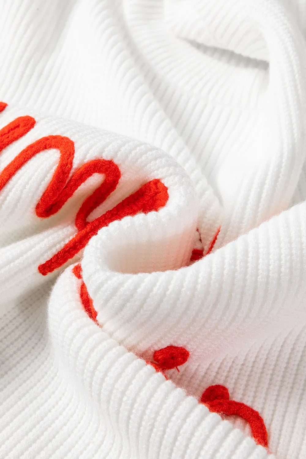 White ribbed knit sweater with red embroidered "HELLO PUMPKIN" text.