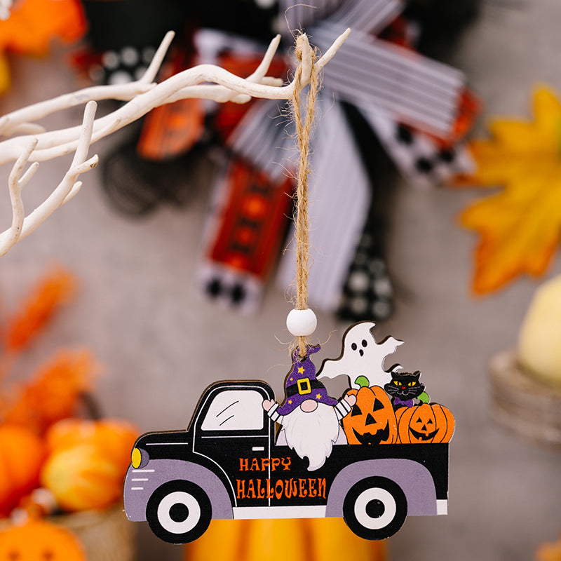 A wooden Halloween car-shaped hanging ornament featuring a gnome, ghost, cat, and pumpkins.