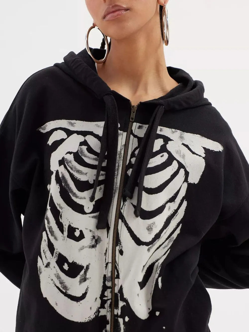 Black zip-up hoodie with a white skeleton rib cage graphic.