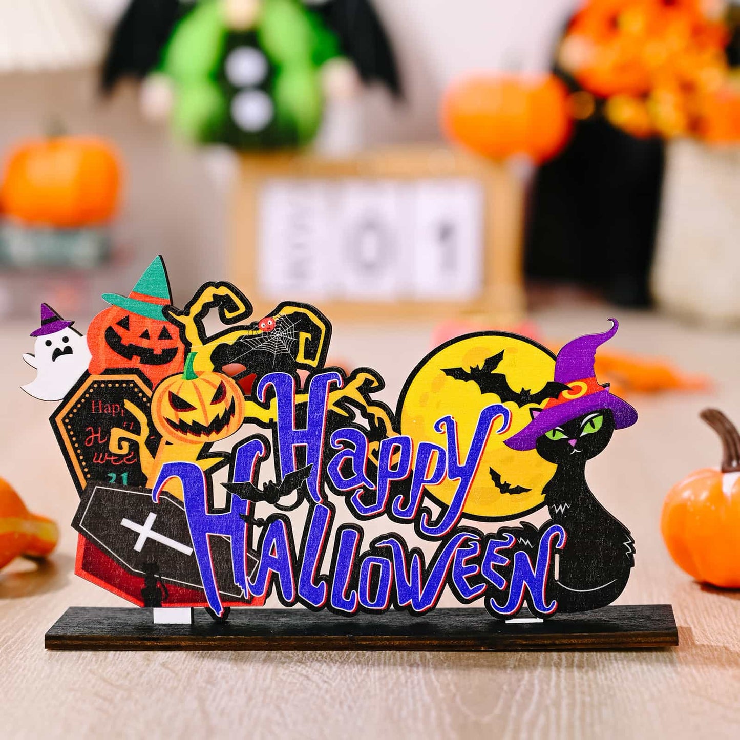 A wooden Halloween decoration featuring a black cat, pumpkins, and the words "Happy Halloween."