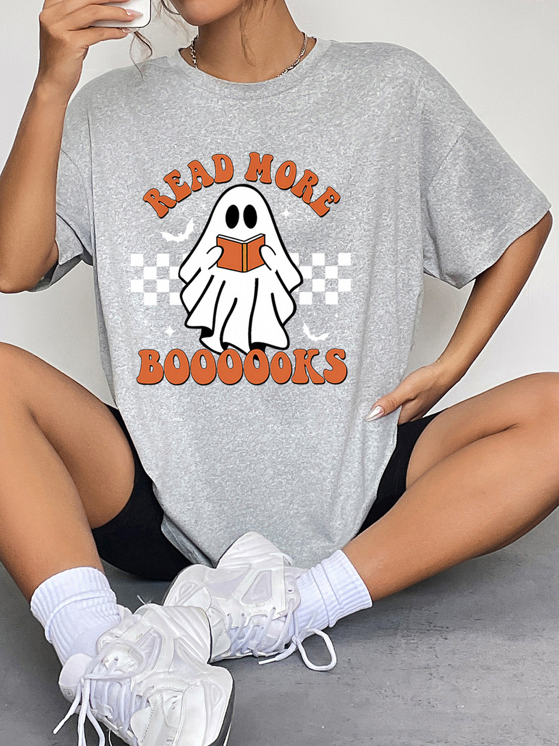 Gray short-sleeve t-shirt with a ghost graphic reading a book.