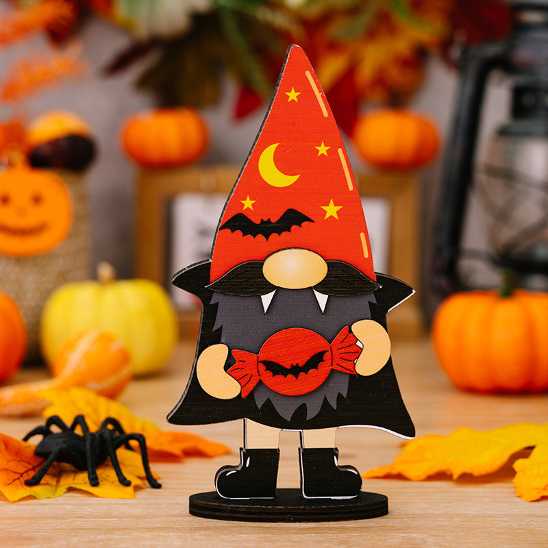 A wooden Halloween gnome ornament with a red hat, black beard, and candy.