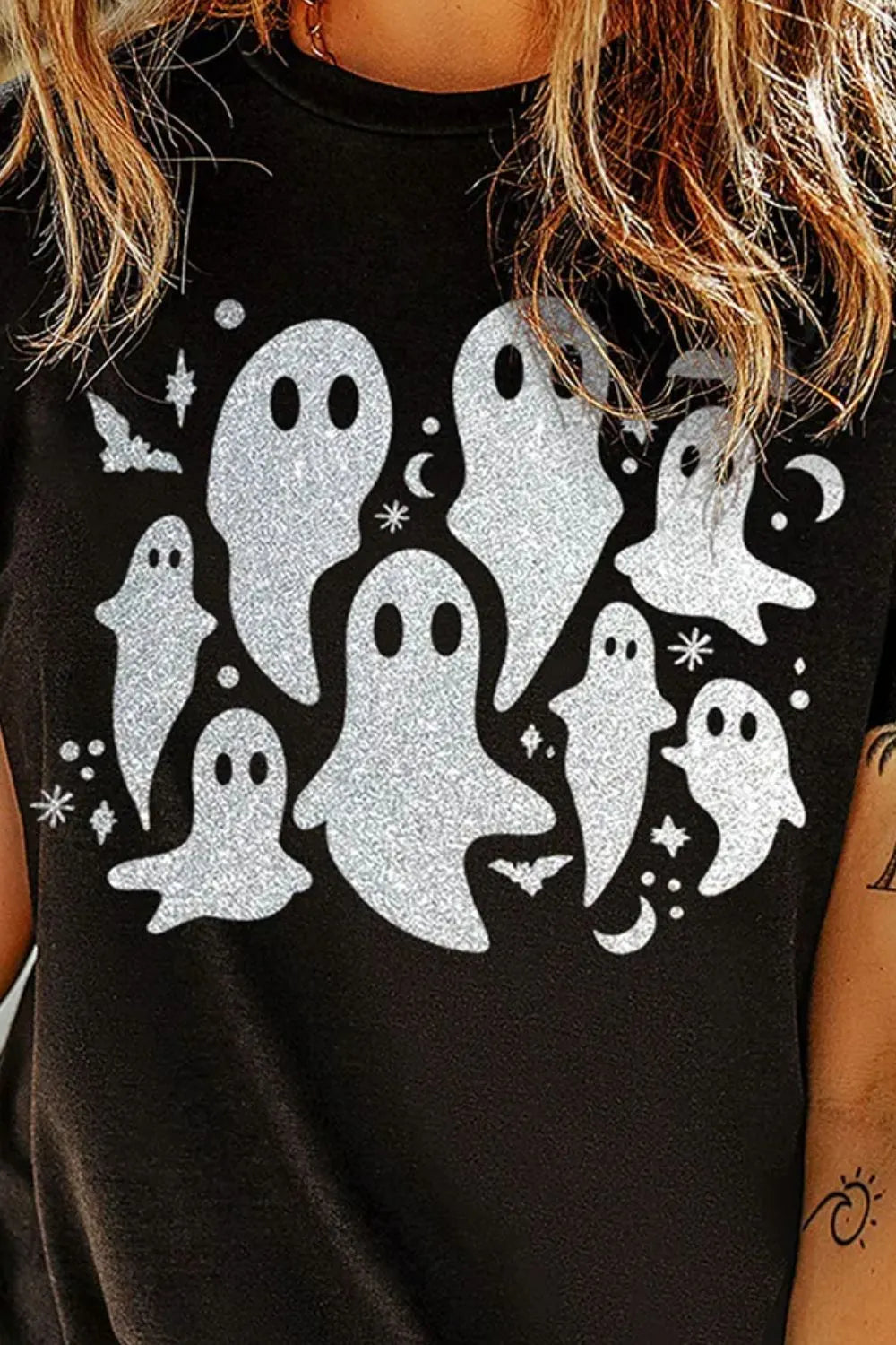 A black short-sleeve t-shirt with a glittery ghost and bat design.