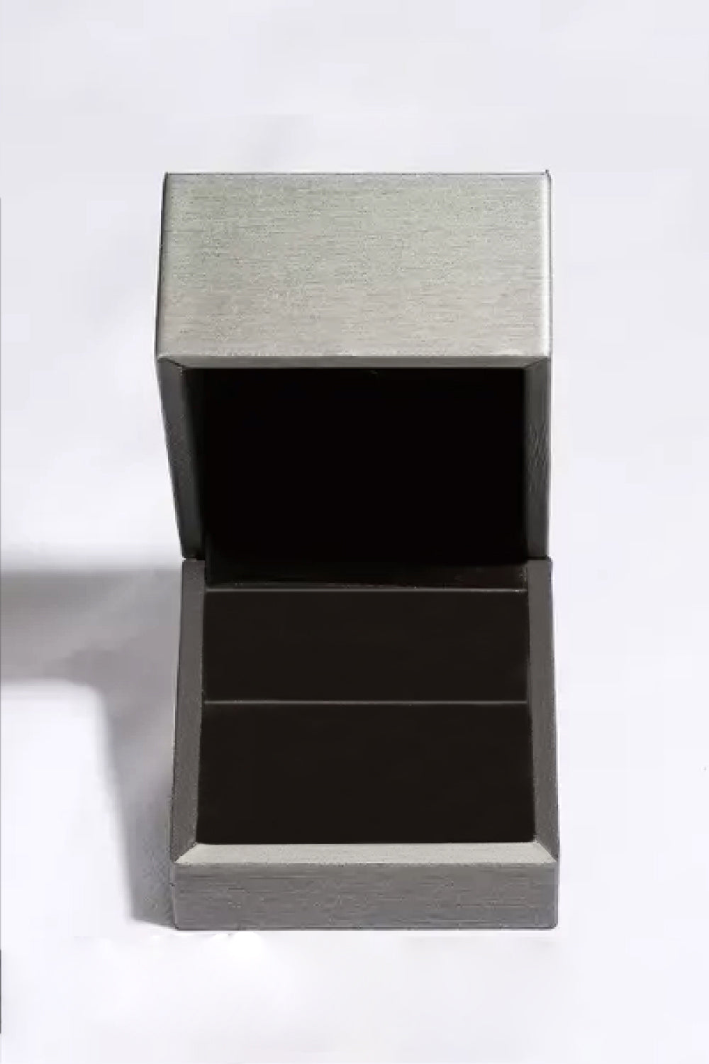An open, empty, dark gray jewelry box with a light gray lid.