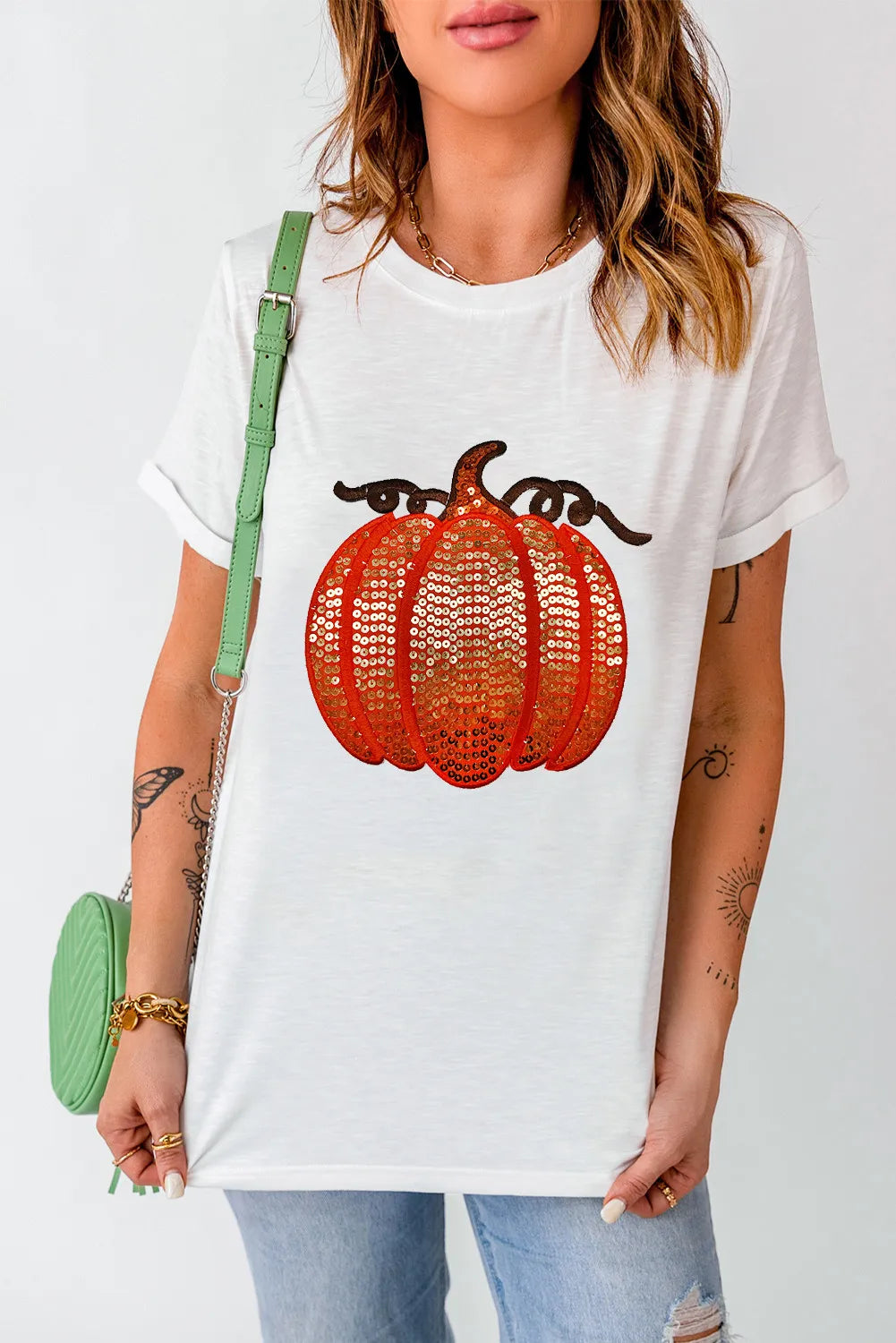 White short-sleeve t-shirt with a sequin pumpkin design.