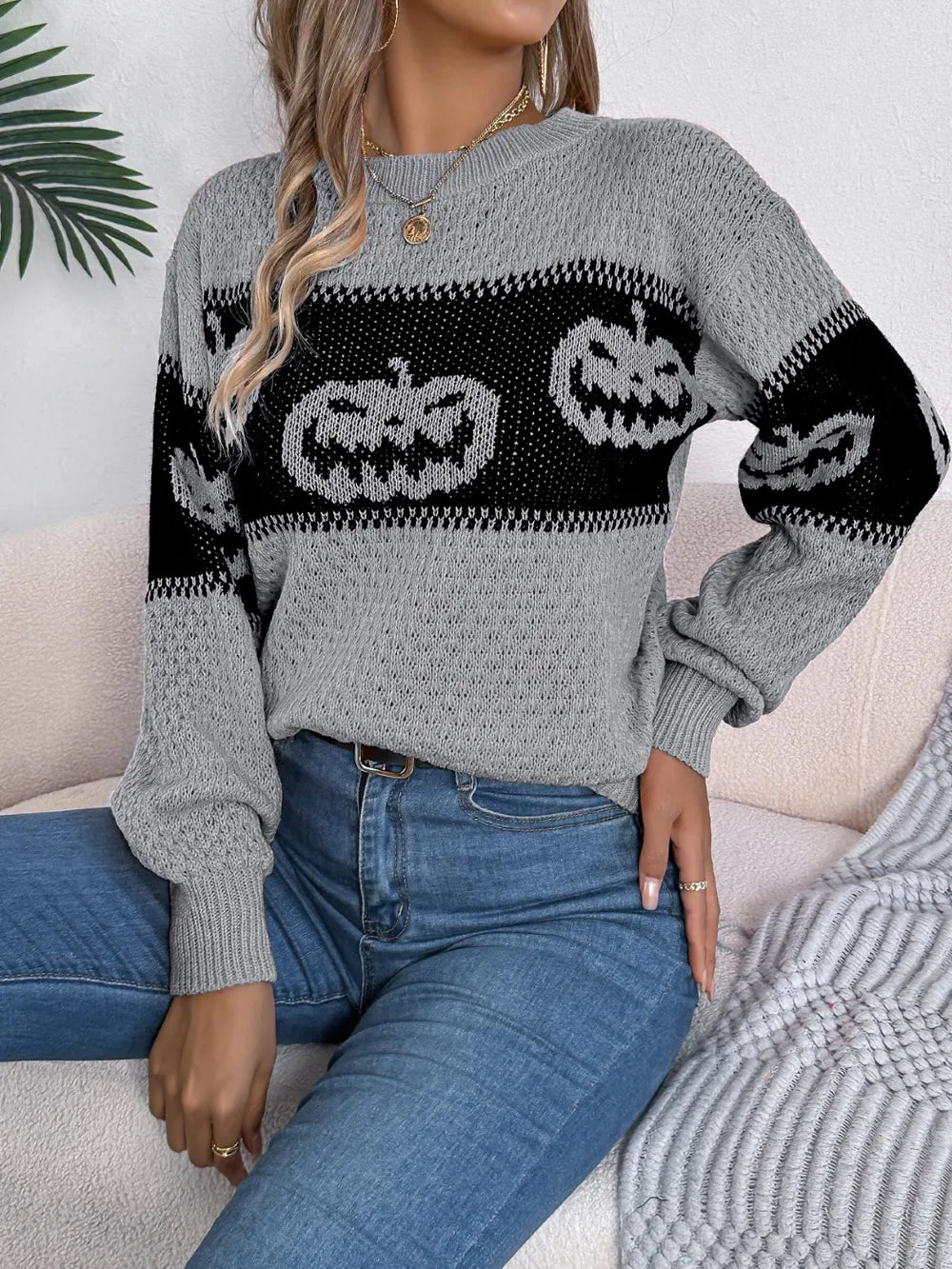 Gray long-sleeve sweater with black pumpkin designs.