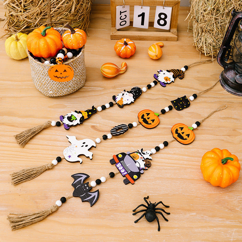 Three Halloween-themed hanging widgets with black and white beads and jute tassels.
