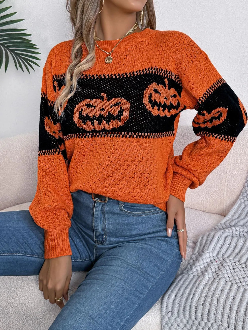Orange and black pumpkin print long sleeve sweater.