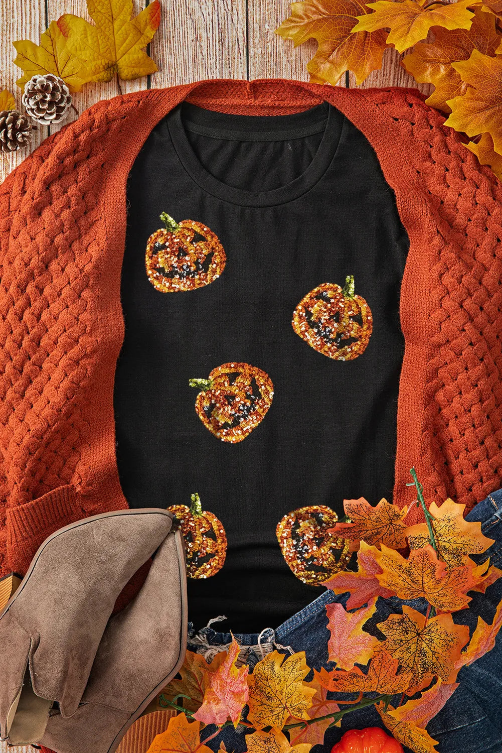 Black short-sleeve t-shirt with sequin pumpkins, paired with an orange cardigan.