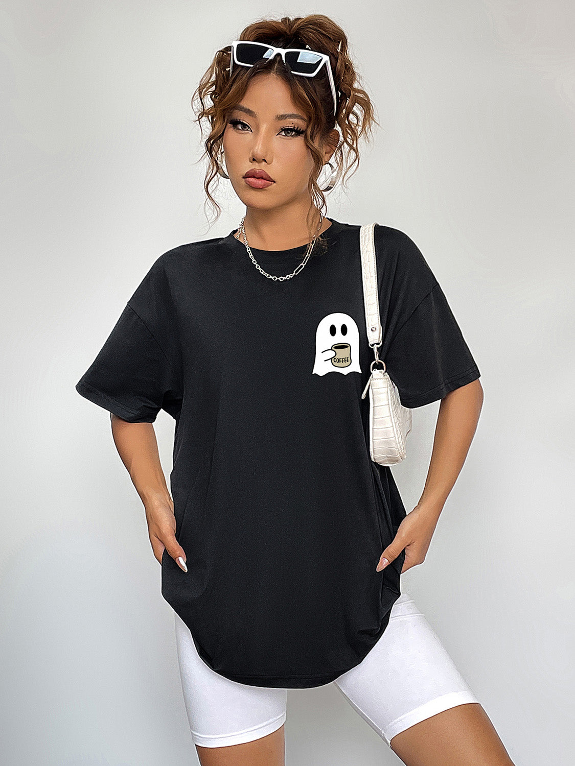 Black short-sleeve t-shirt with a ghost holding coffee graphic.