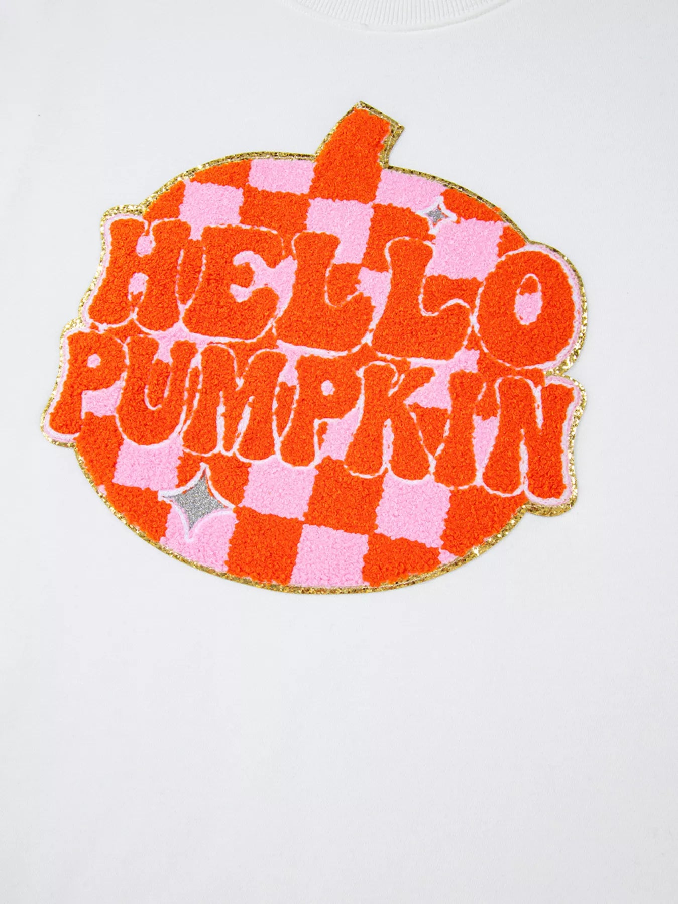 White long-sleeve sweatshirt with a "Hello Pumpkin" patch in orange and pink checkerboard.