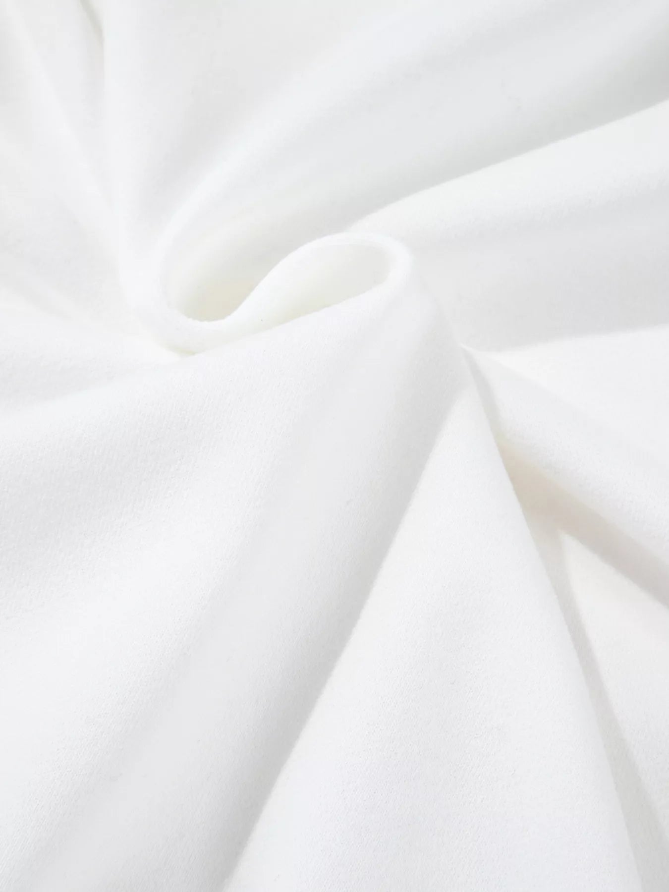 White fabric with soft folds and subtle texture.
