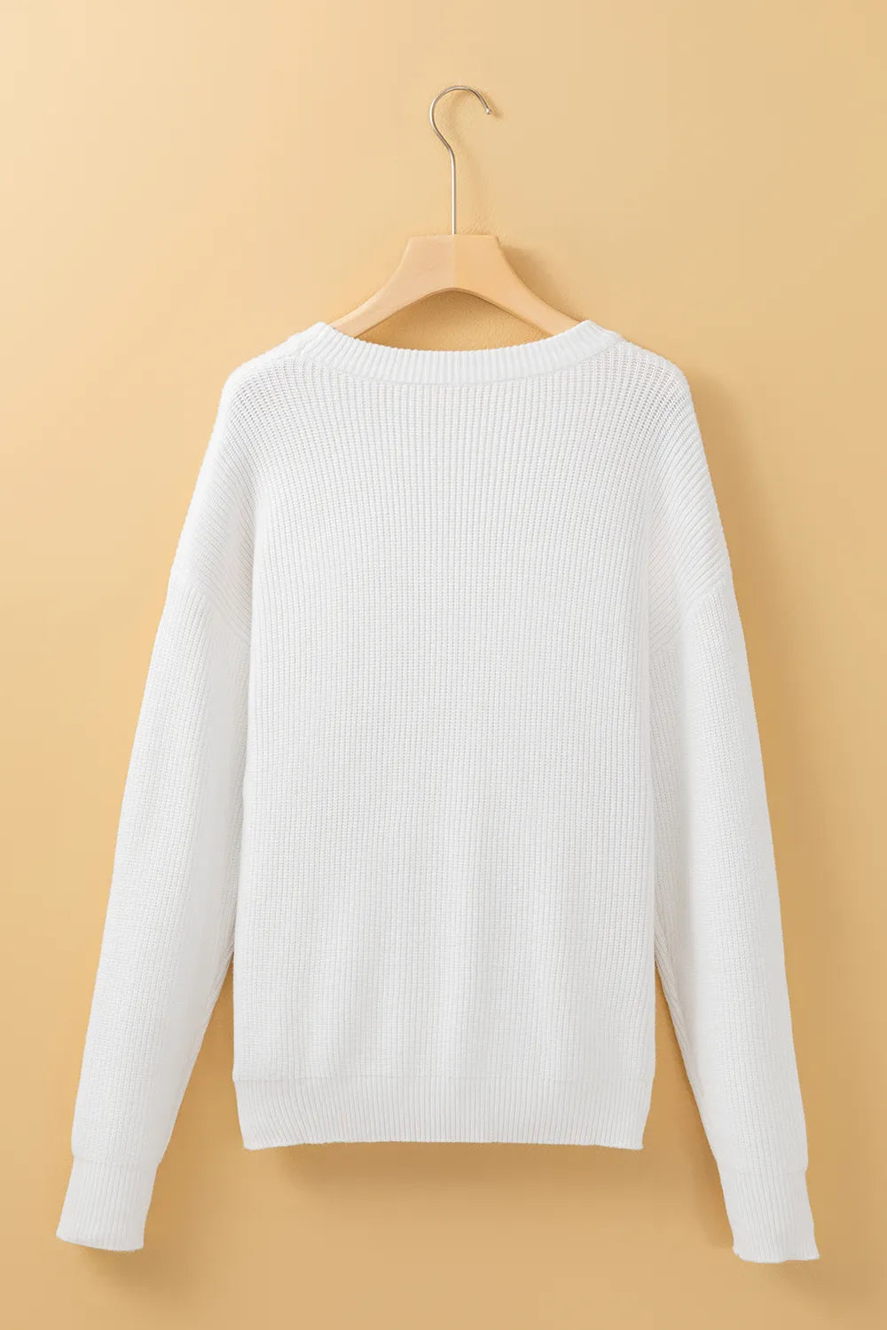 White round neck long sleeve sweater on a hanger.