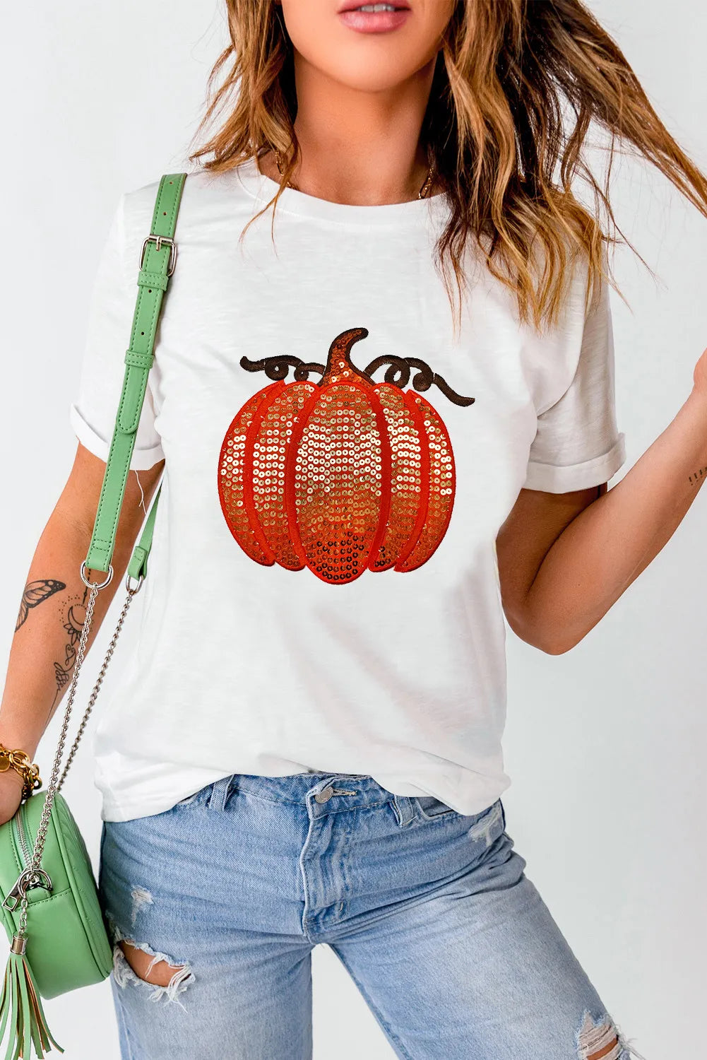 White short-sleeve t-shirt with a full-size sequin pumpkin design.
