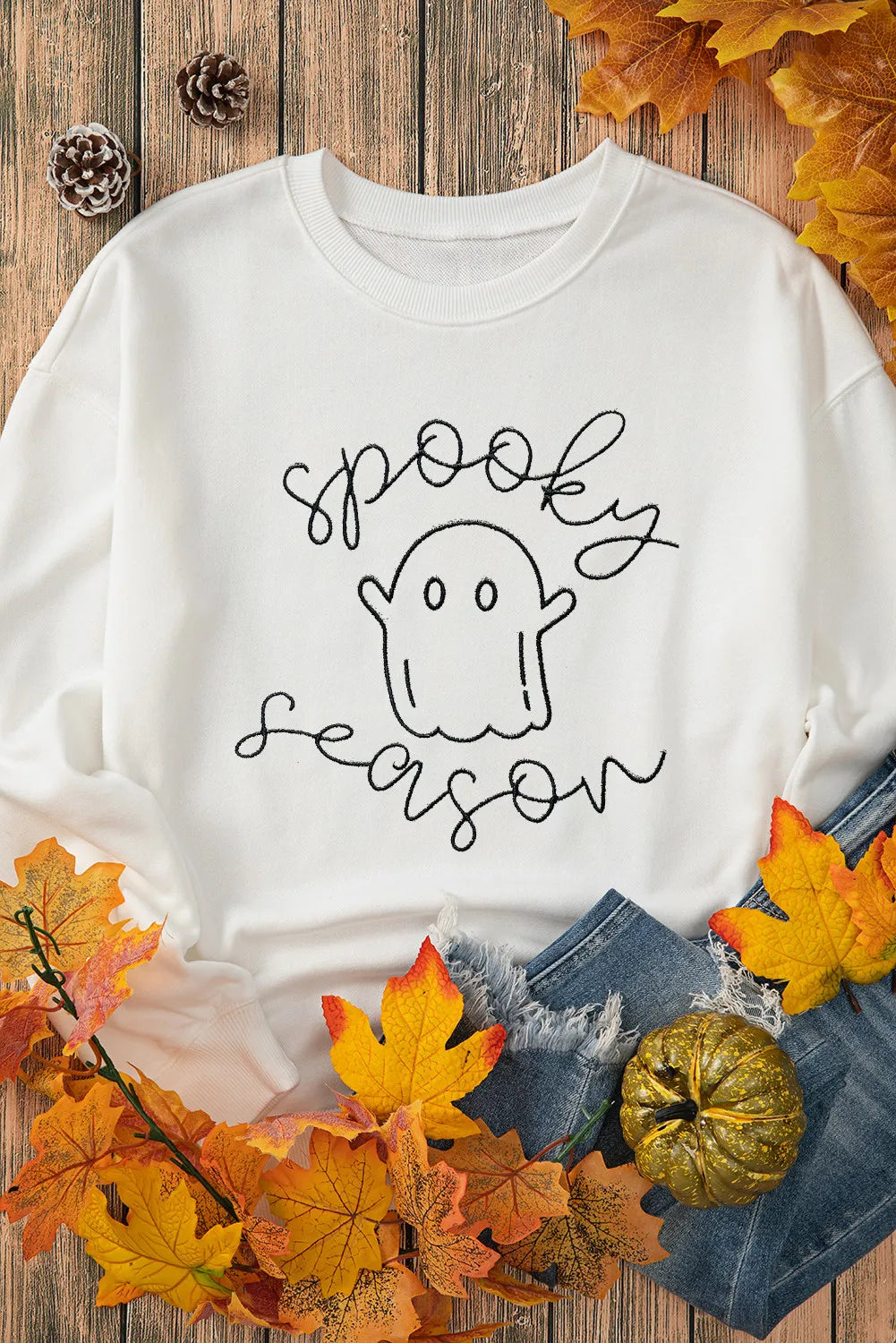 White long-sleeve sweatshirt with "spooky season" and a ghost graphic.