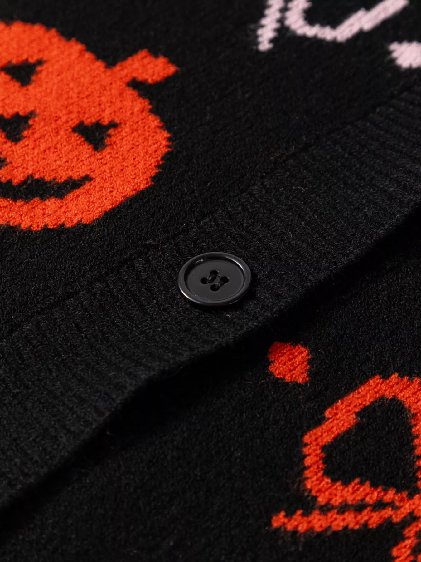 Black button-up cardigan with orange Halloween pumpkin patterns.