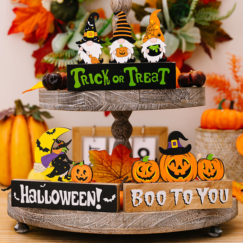 Assorted Halloween element ornaments displayed on a two-tiered wooden tray.