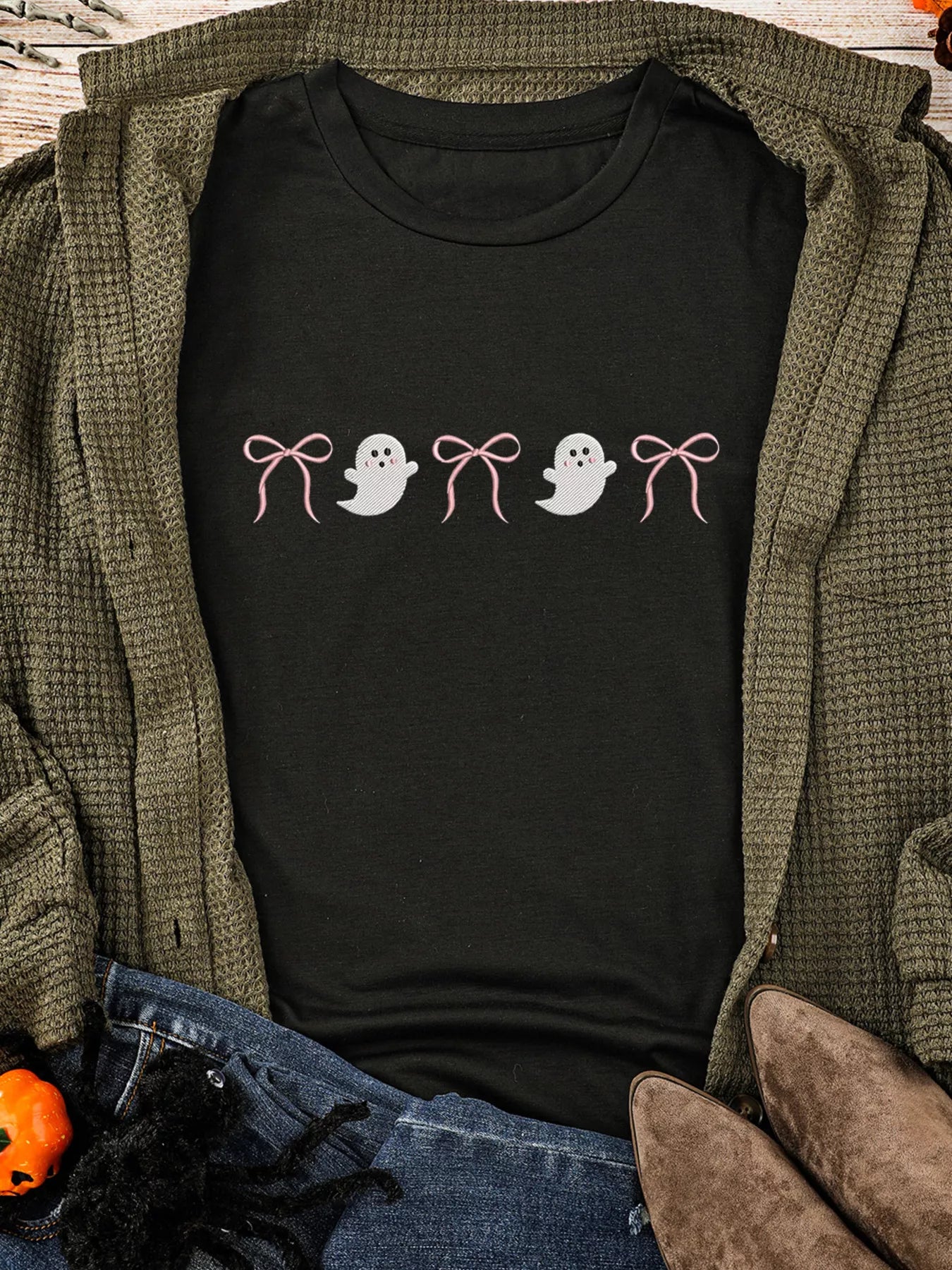 Black short sleeve t-shirt with pink bows and white ghost graphics.