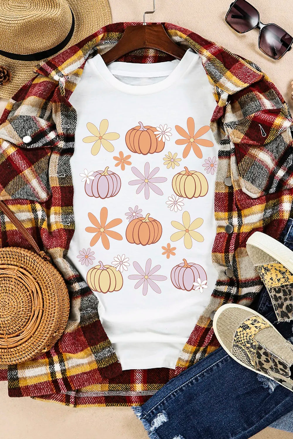 White short-sleeve t-shirt with colorful pumpkin and flower graphics.