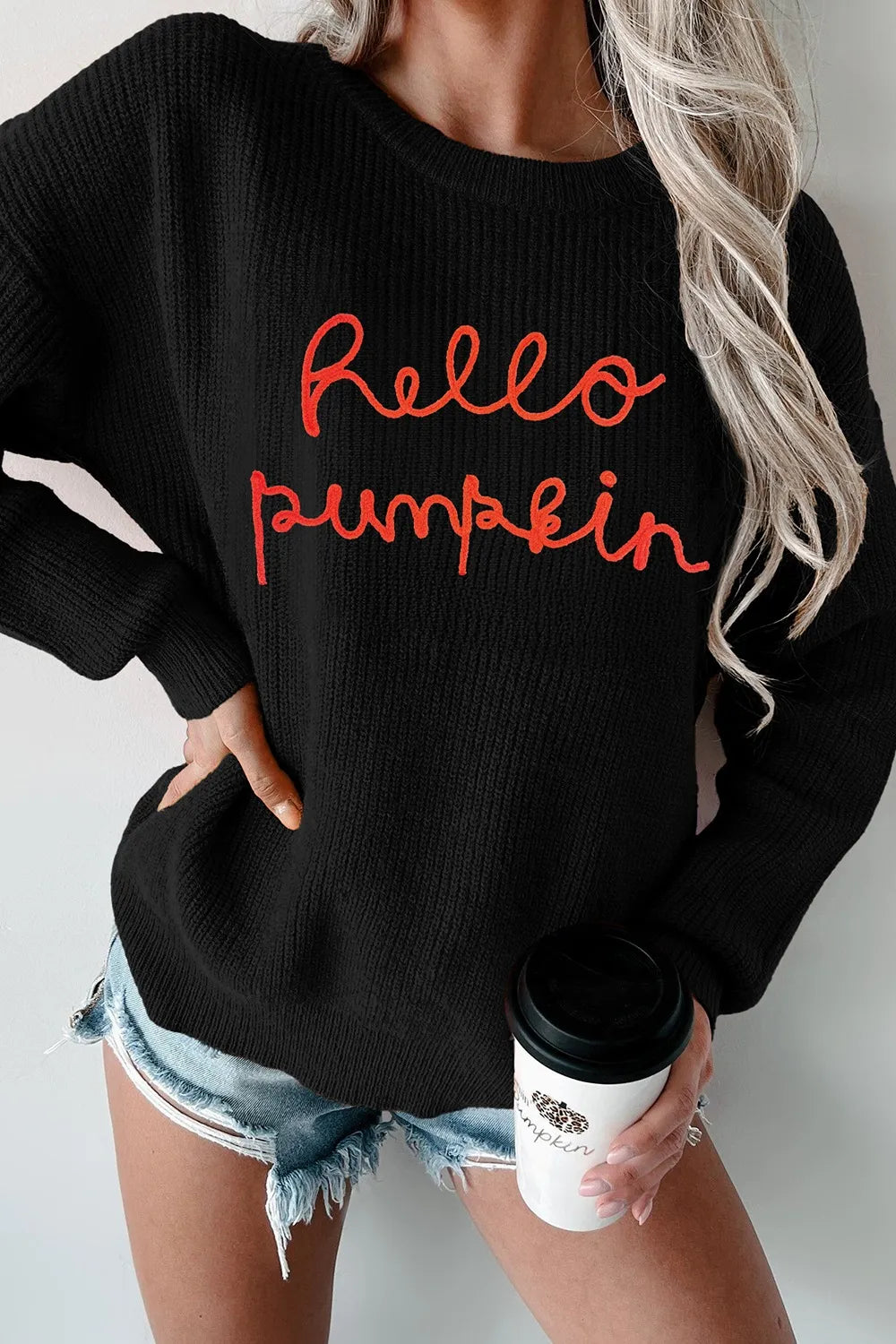 Black "Hello Pumpkin" round neck long sleeve sweater with distressed denim shorts.