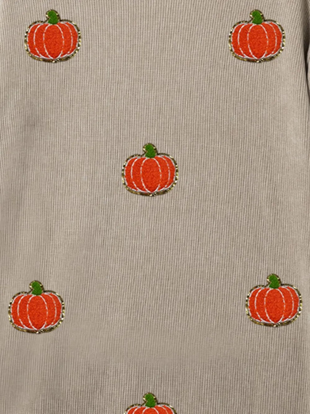 A beige long-sleeve sweatshirt with embroidered orange pumpkins.