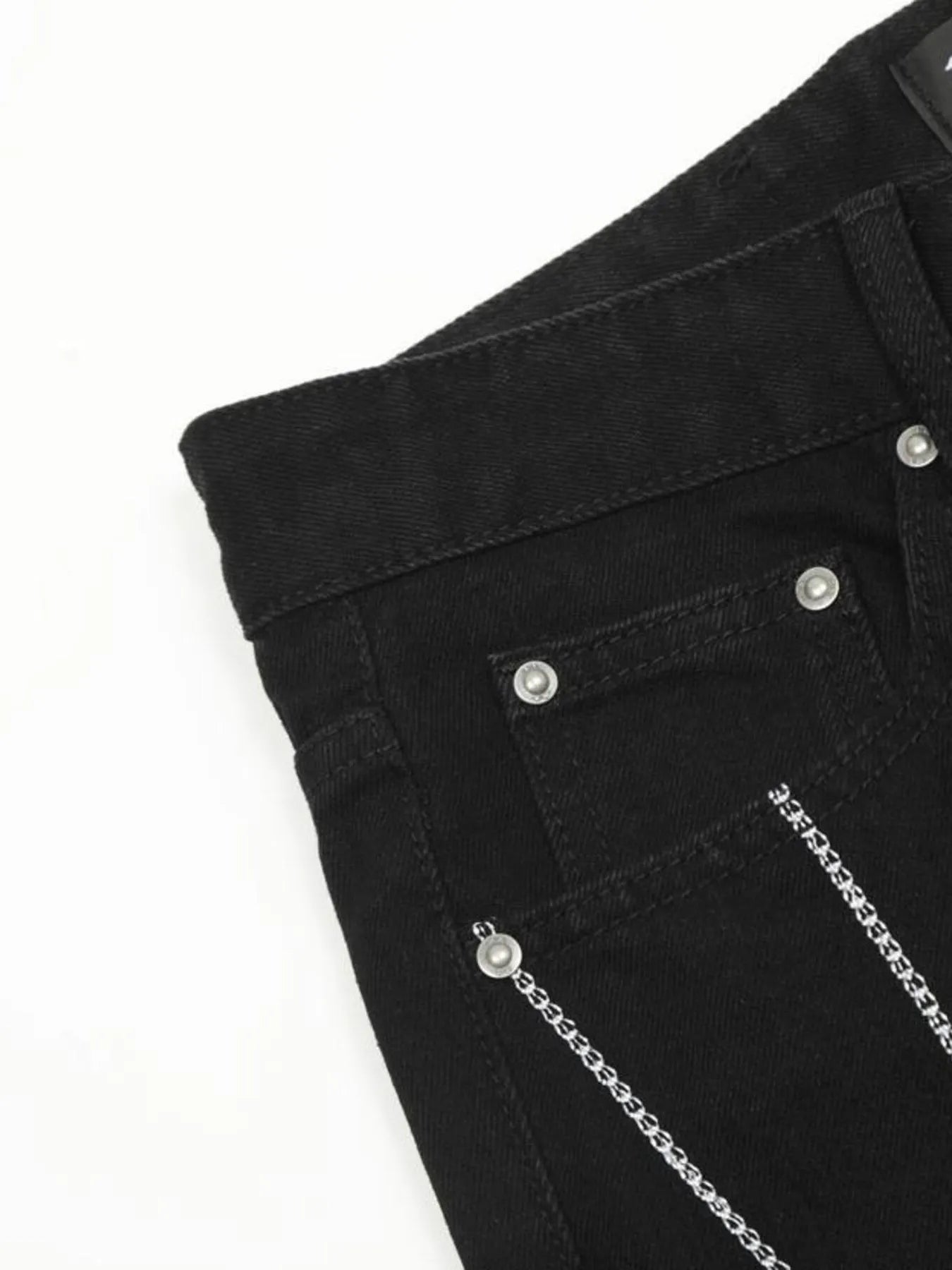 Black men's jeans with silver chains and rivets.