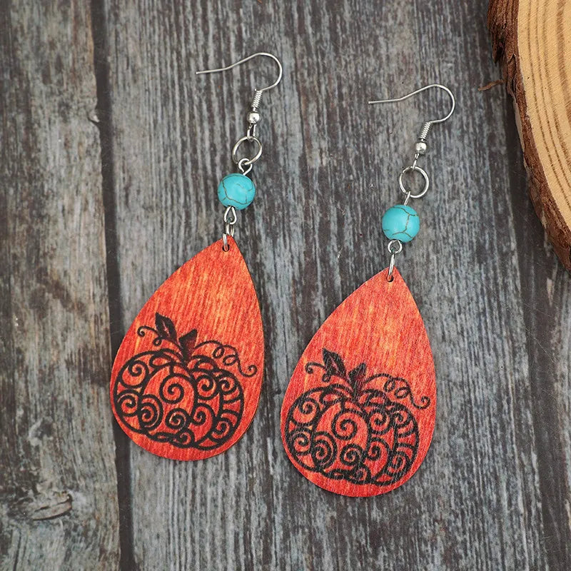 Turquoise wooden pumpkin teardrop earrings.