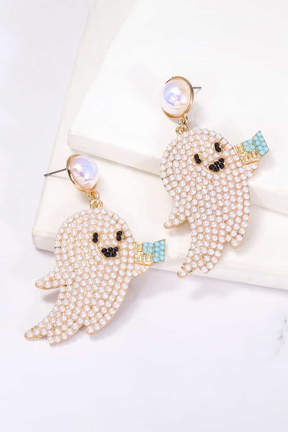 Ghost-shaped dangle earrings adorned with synthetic pearls and a "BOO" sign.