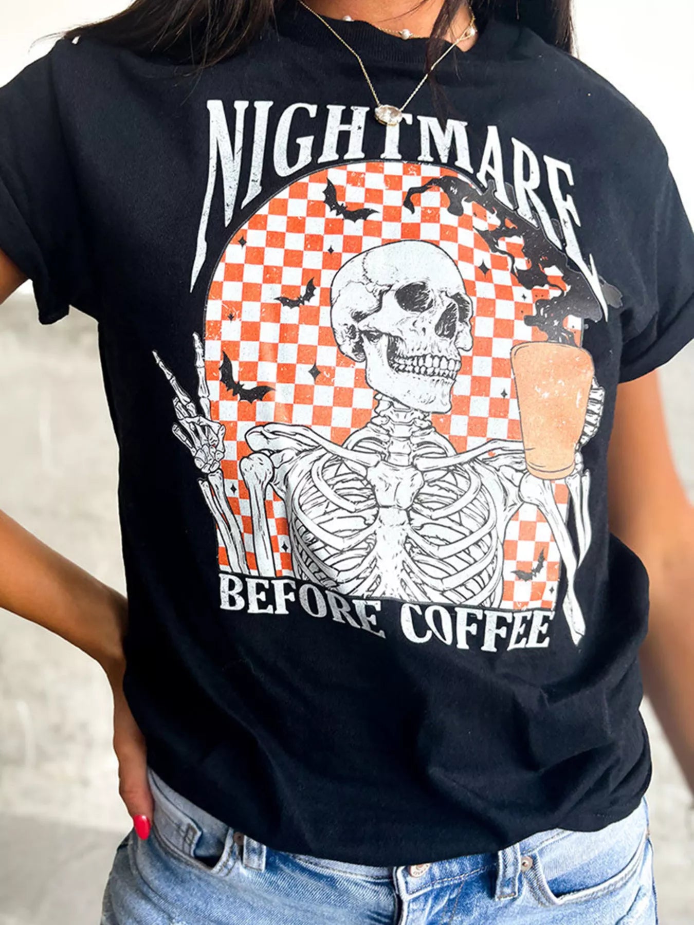 Black tee with a skeleton holding coffee and making a peace sign.