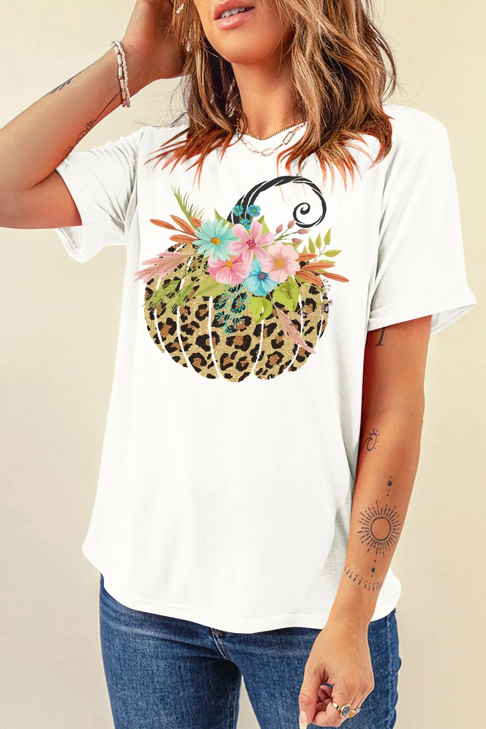 White short-sleeve t-shirt with a leopard print pumpkin and floral graphic.