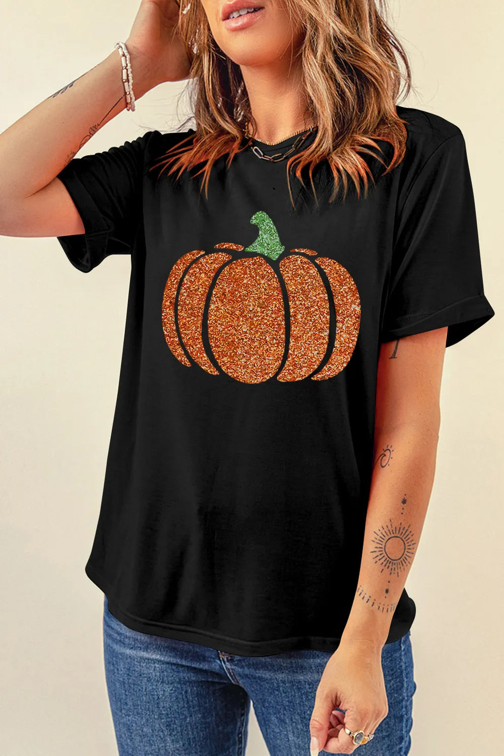 Black short-sleeve t-shirt with a glitter pumpkin design.