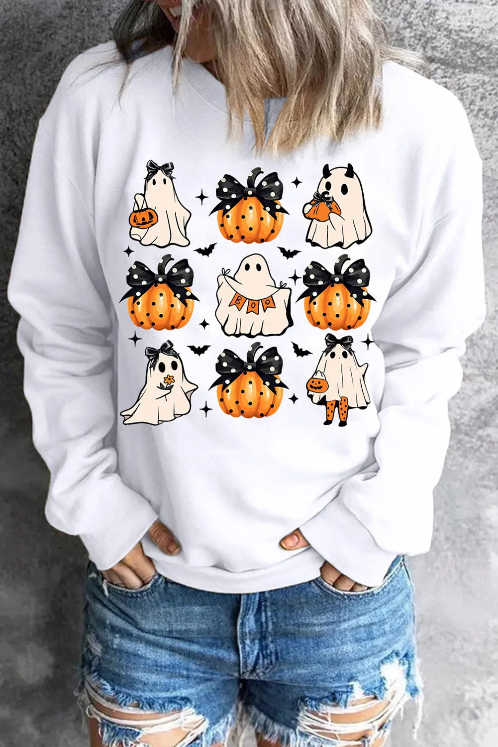 White long-sleeve sweatshirt with a Halloween ghost and pumpkin graphic print.
