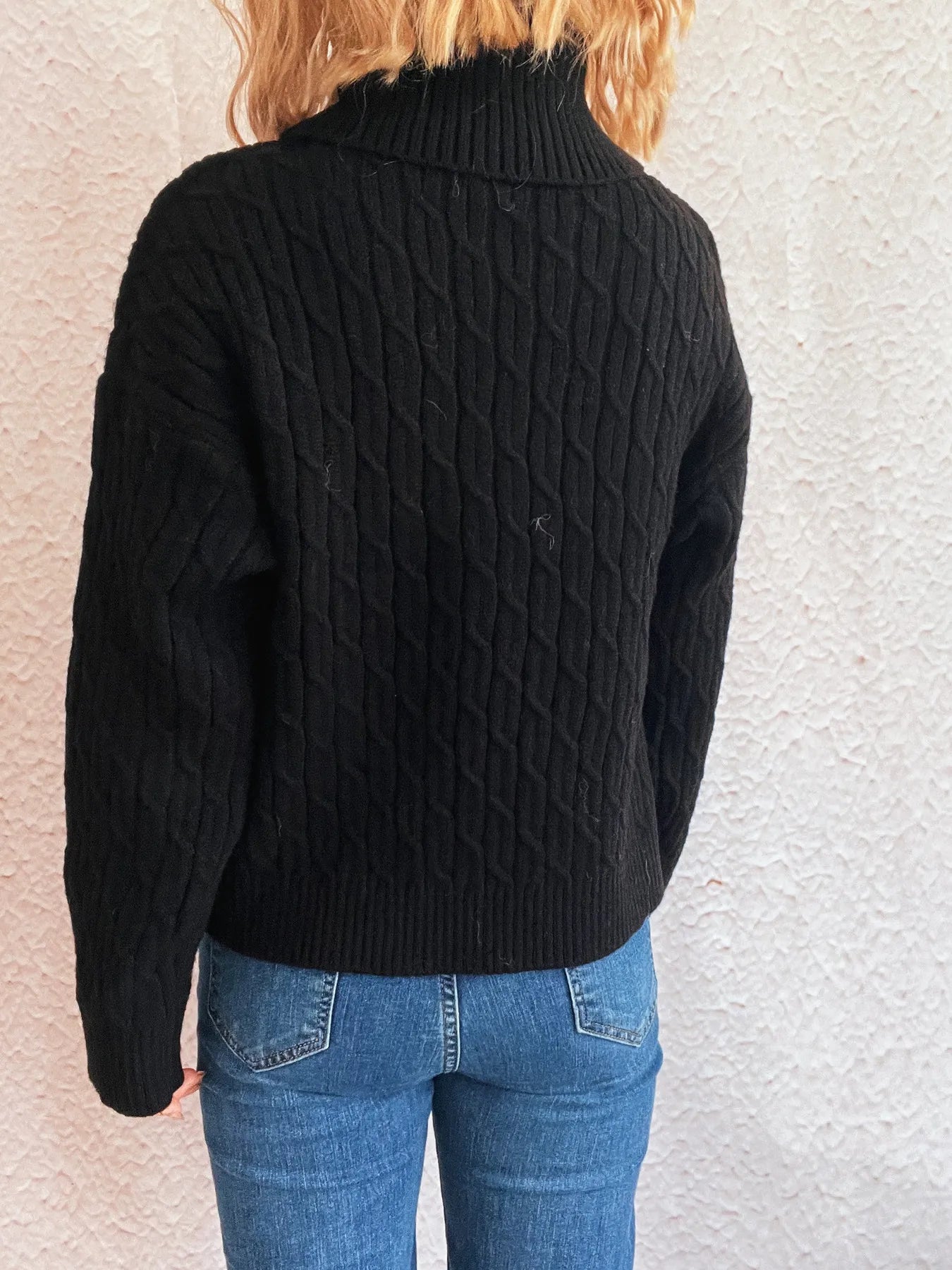 Pumpkin turtleneck long sleeve sweater with a cable-knit pattern.
