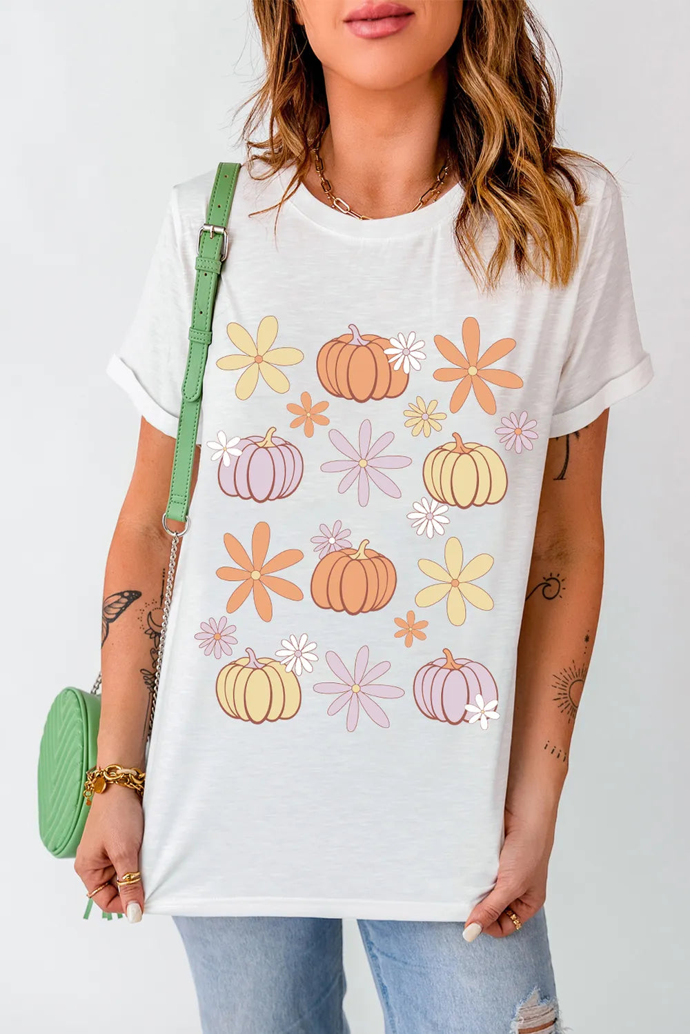 White short-sleeve t-shirt with a pumpkin and flower pattern.