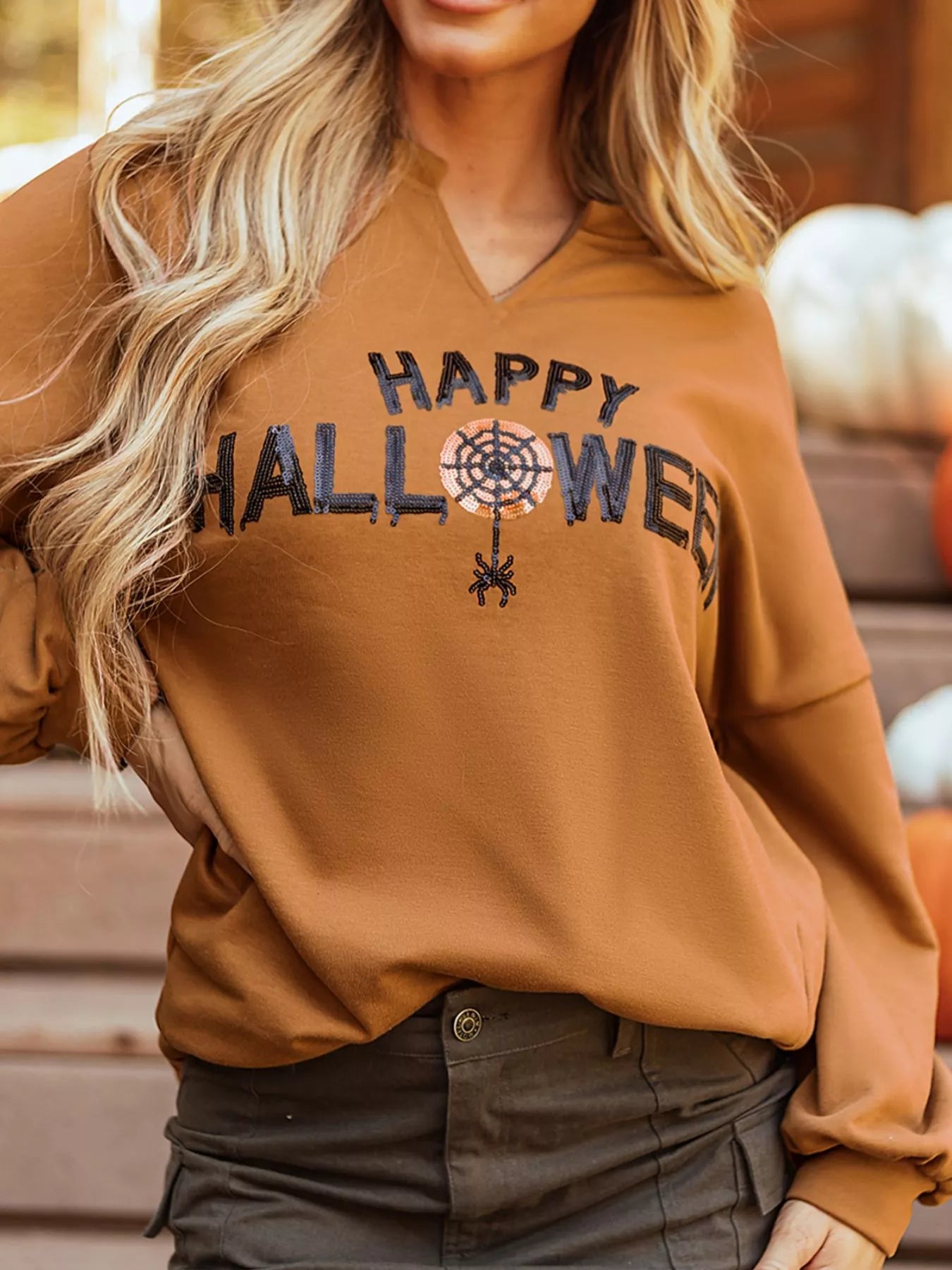 Happy Halloween graphic notched long sleeve loose top.