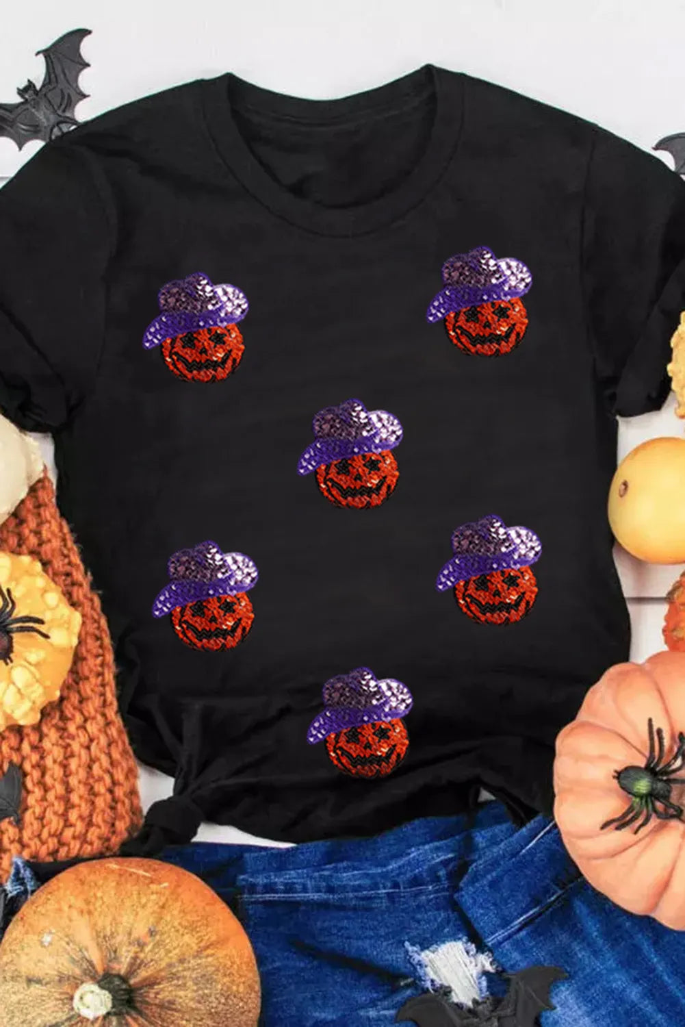 Black short-sleeve t-shirt with sequin pumpkin designs.