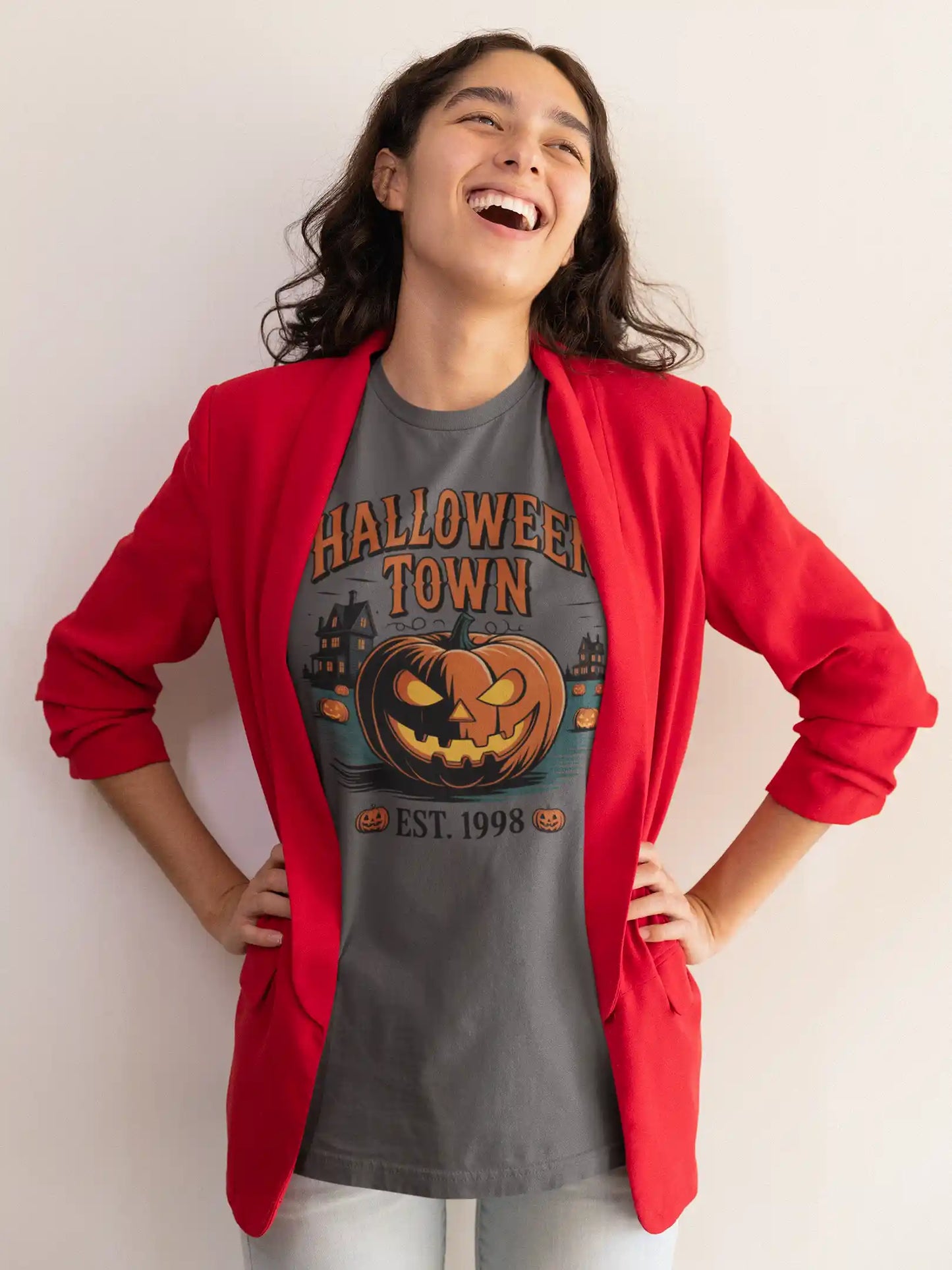 A woman in a red blazer wears a gray Halloween Town t-shirt with a pumpkin graphic.