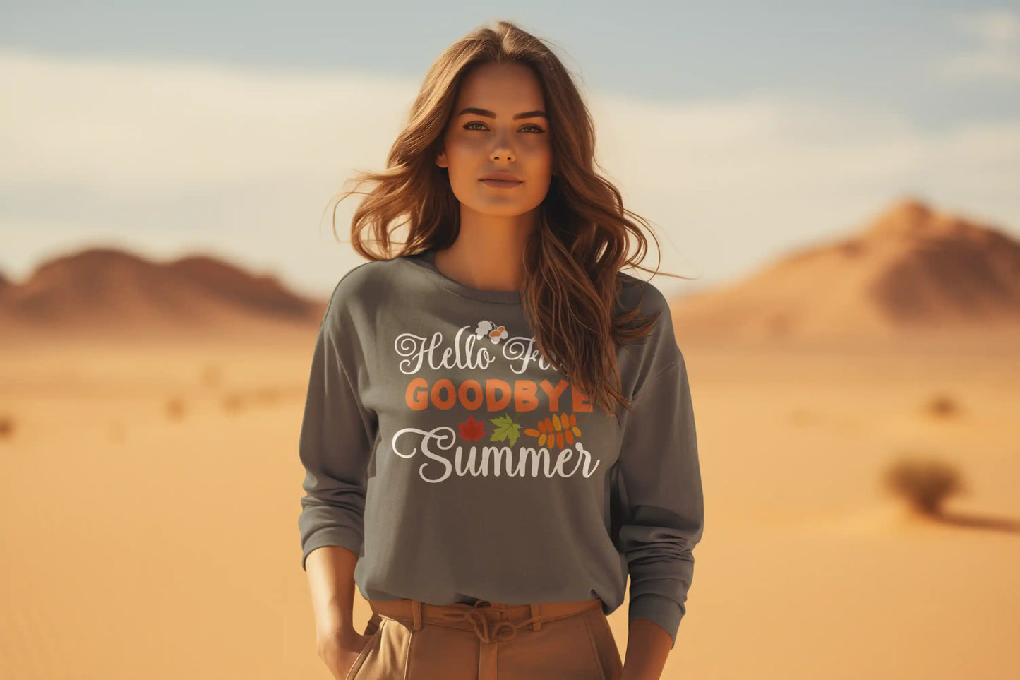 A woman in a desert wears a gray sweatshirt with "Hello Fall GOODBYE Summer" text.