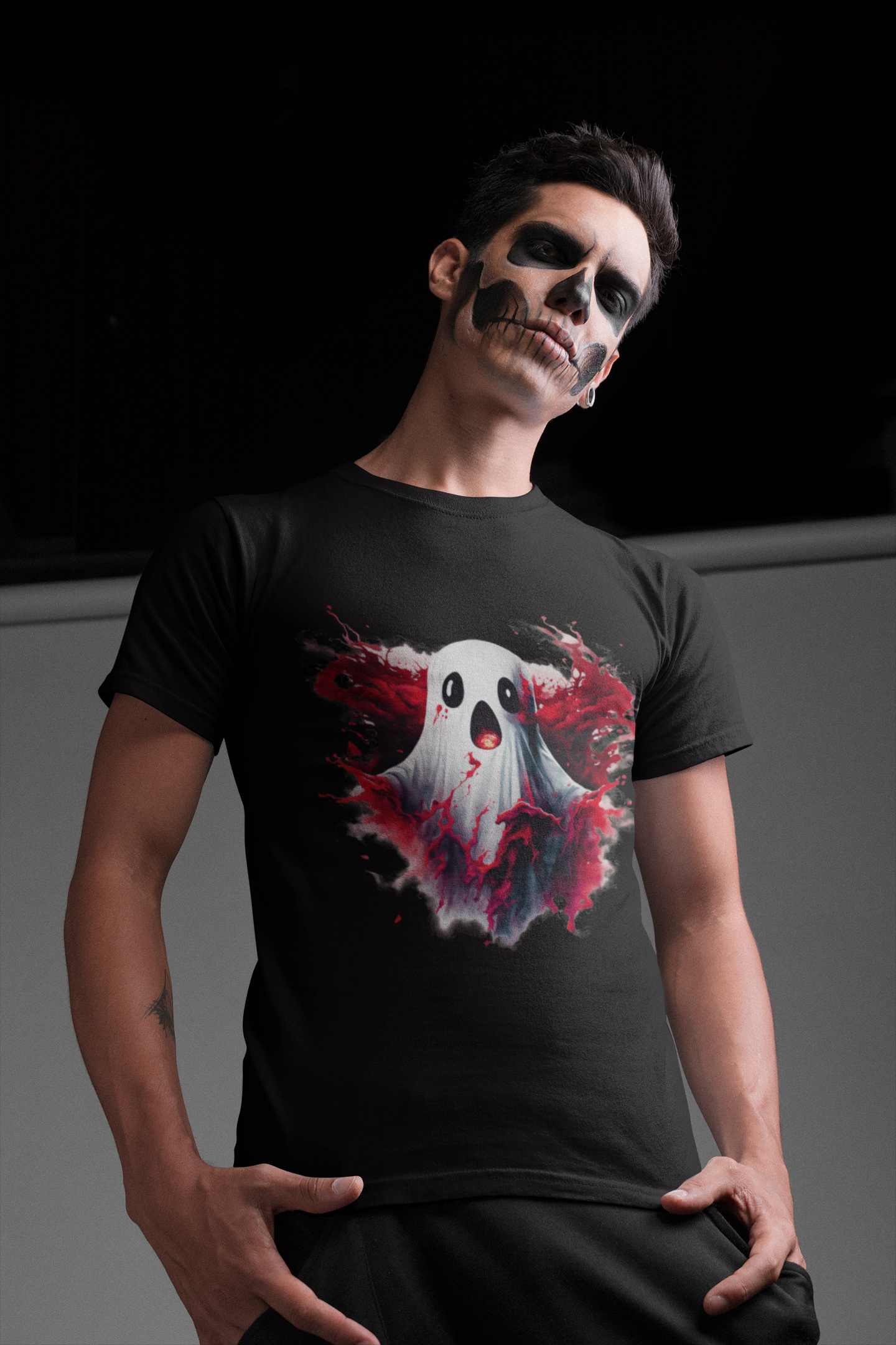 A man in skull makeup wears a black t-shirt with a creepy ghost design.