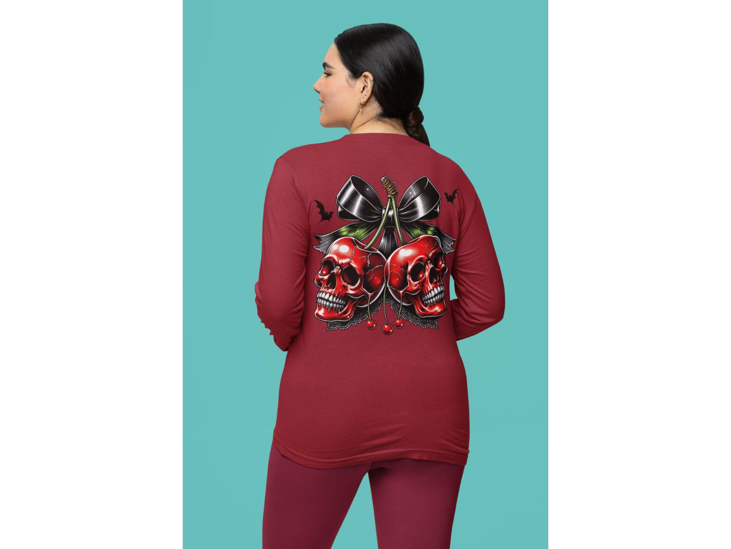 A woman from behind wears a red long-sleeve shirt with a spooky cherry Halloween bow design.