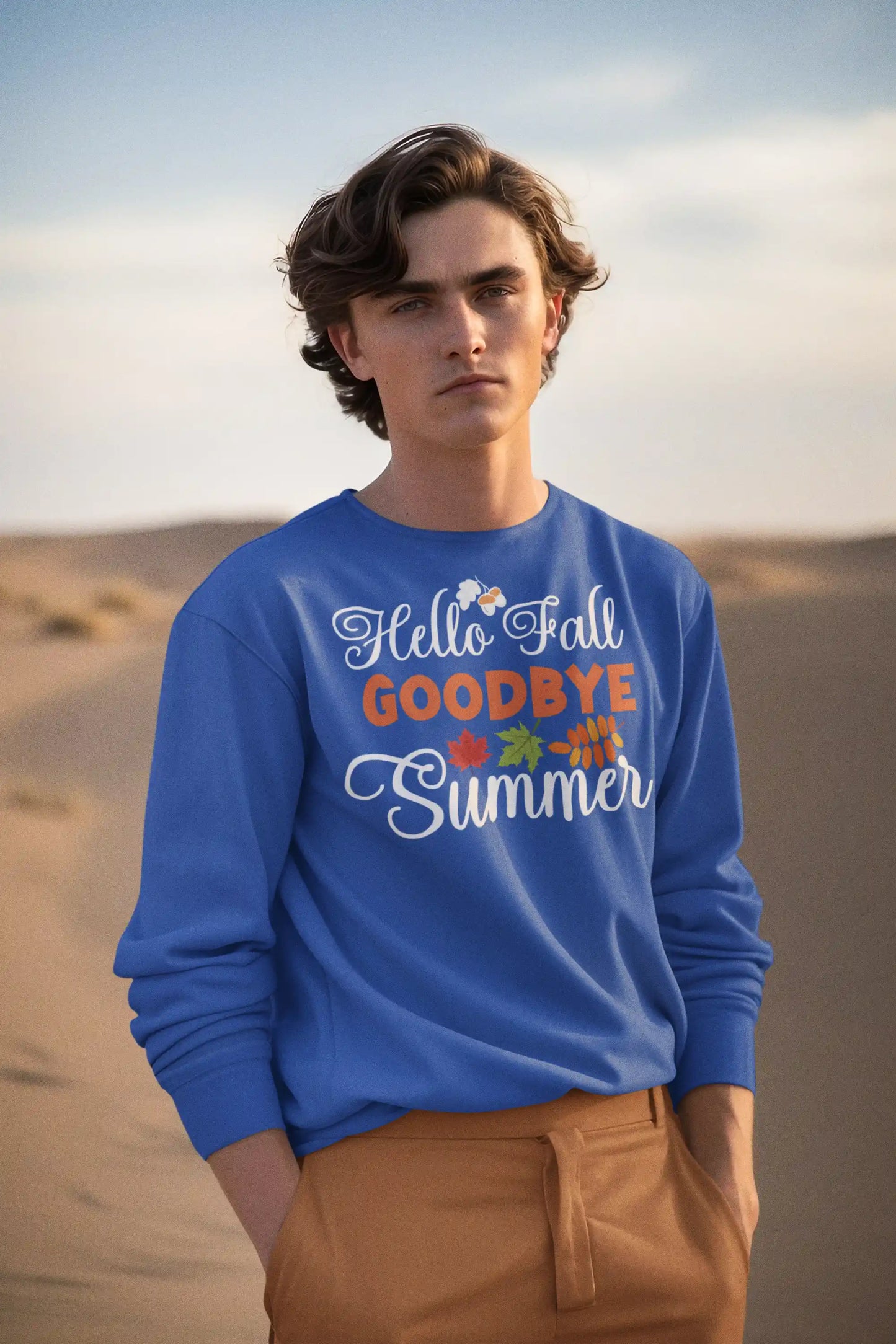 A man wears a blue "Hello Fall GOODBYE Summer" sweatshirt with brown pants.