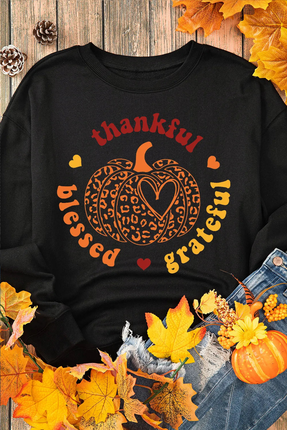 Black long sleeve sweatshirt with a "thankful blessed grateful" pumpkin graphic.