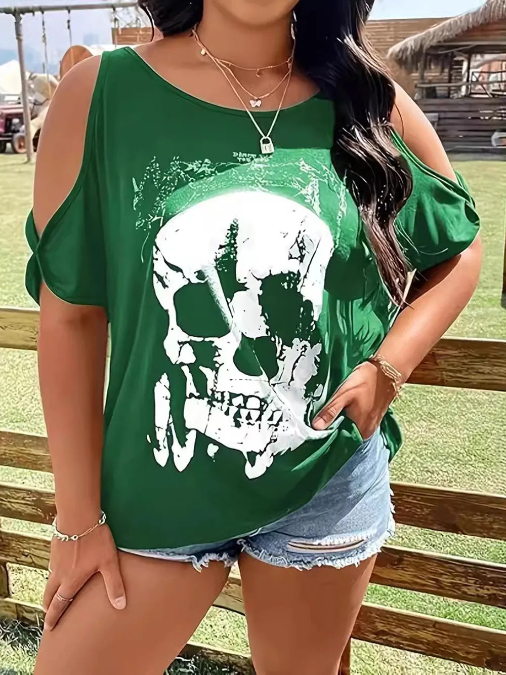 Plus size green cold shoulder t-shirt with a white skeleton graphic.