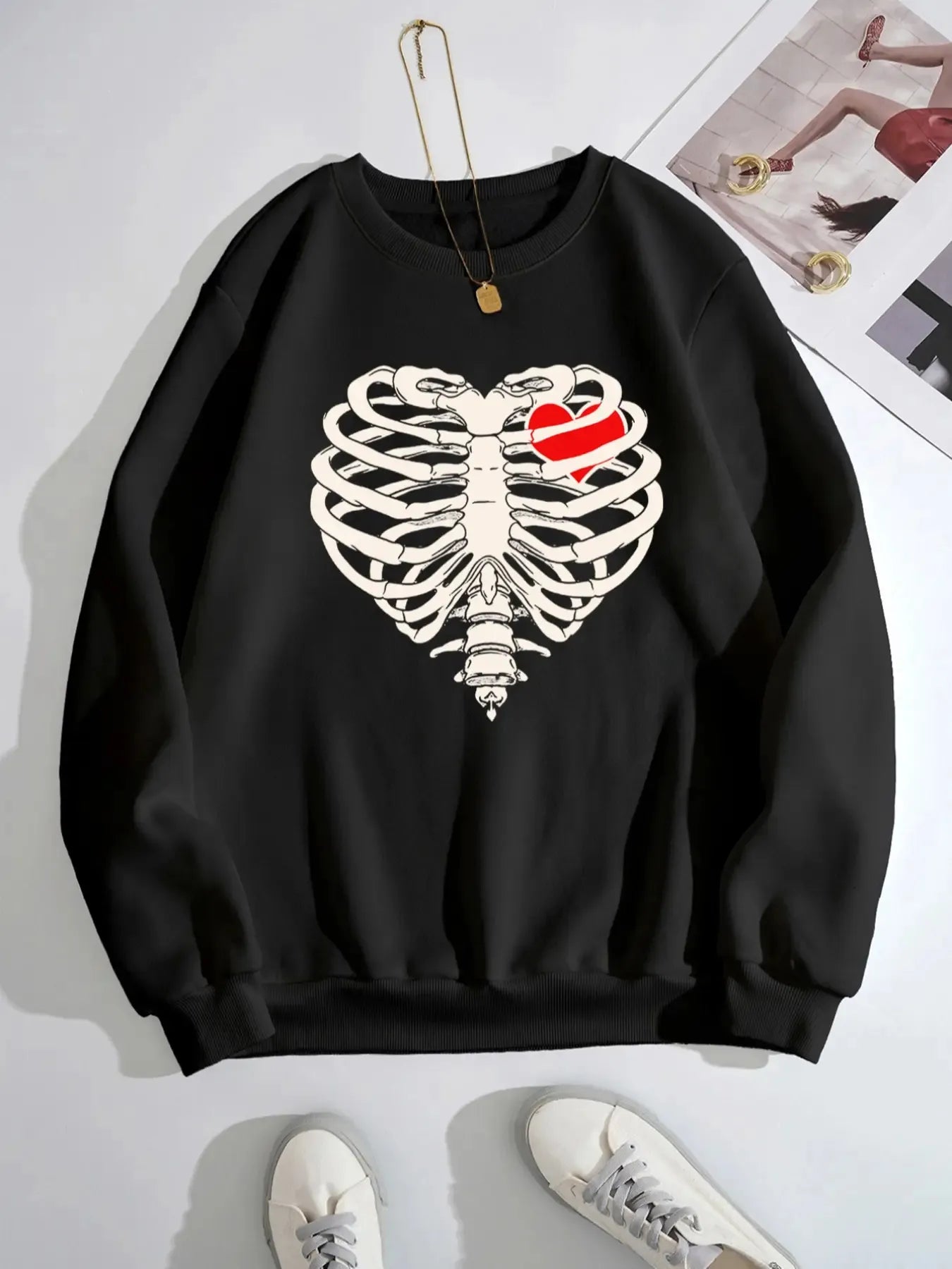 Black sweatshirt with a white skeleton rib cage and a red heart design.