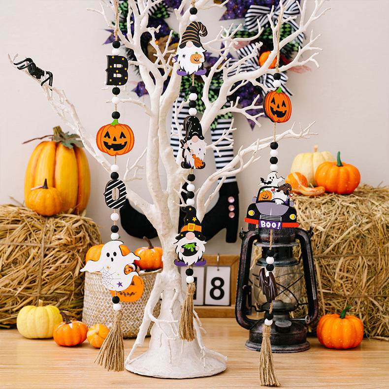 Three Halloween-themed wooden hanging ornaments featuring gnomes, pumpkins, and ghosts.